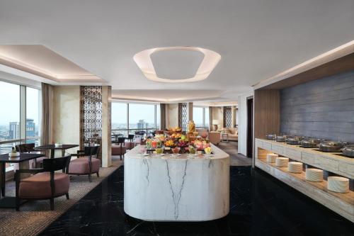a hotel lobby with a table with flowers on it at JW Marriott Hotel Surabaya in Surabaya