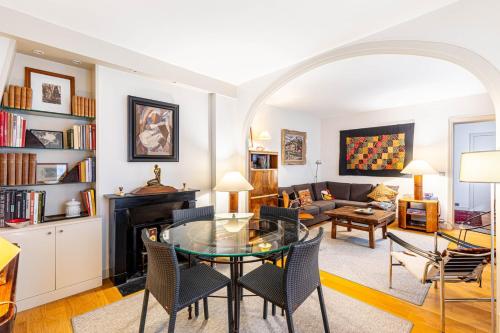 un salon avec une table en verre et des chaises dans l'établissement GuestReady - Magnificent stay in the 3rd Arr., à Paris