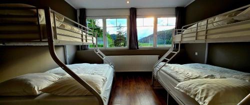 two bunk beds in a room with a window at The Art and Sporthotel in Innsbruck