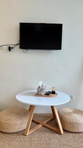 a white table in a room with a tv at 山有巷宅 Alley House in Puli