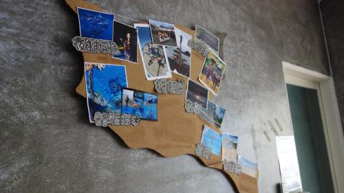 a collage of pictures hanging on a wall at Lanyu Blue Capsule in Lanyu
