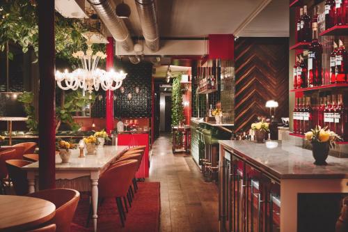 ein Restaurant mit einer Bar mit Tischen und Stühlen in der Unterkunft Grand Ferdinand Vienna – Your Hotel In The City Center in Wien