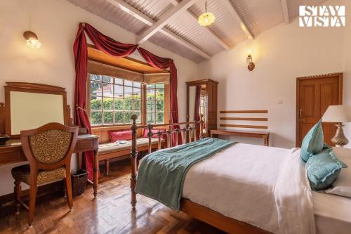 a bedroom with a bed and a desk and a window at StayVista at Greenwood Bungalow - Indoor & Outdoor Game in Ooty
