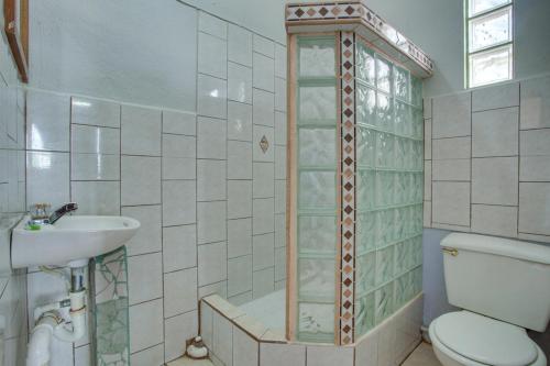 a bathroom with a toilet and a sink at Venus Hotel in San Ignacio