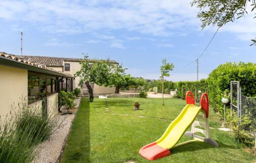 a playground with a slide in a yard at Oriental Muti in Chiaramonte Gulfi