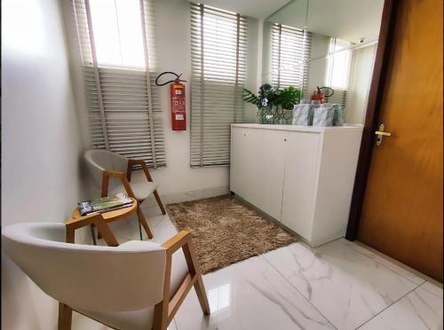 a bathroom with a sink and a chair and a mirror at Hotel Pepita Palace in Sinop