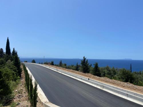 an empty road with trees on the side of it at Yard Paradise Rooms Dhermi in Dhërmi
