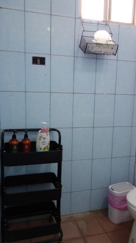 a bathroom with a black shelf with a white toilet at Lanyu Blue Capsule in Lanyu
