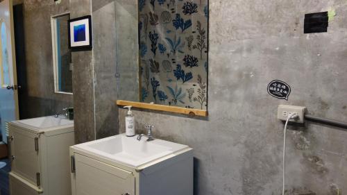 a bathroom with a sink and a mirror at Lanyu Blue Capsule in Lanyu
