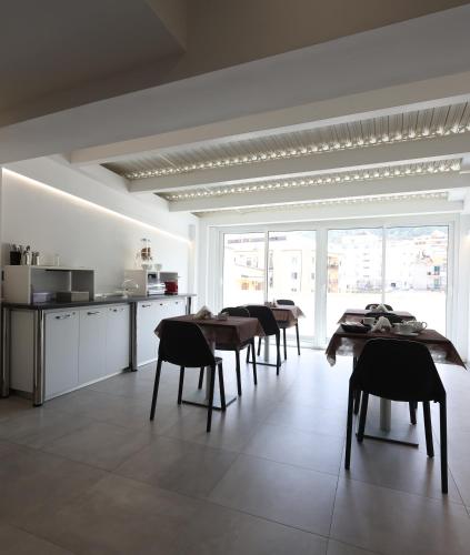 a kitchen with tables and chairs in a room at B&B Sunlight Tropea in Tropea