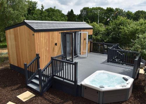 a large wooden deck with a hot tub on it at Watermill Leisure Park 