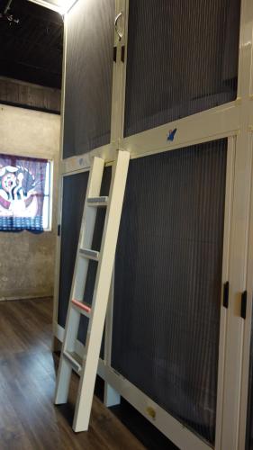 a bunk bed in a room with a ladder at Lanyu Blue Capsule in Lanyu