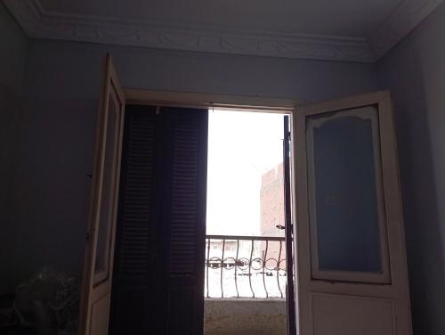 an open door with a view of a balcony at The apartment in Sinnūris