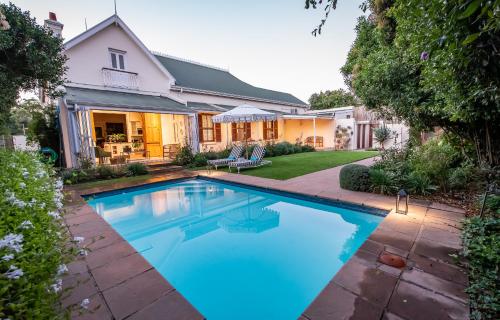 a swimming pool in the backyard of a house at Bonne Esperance Boutique Guest House in Stellenbosch