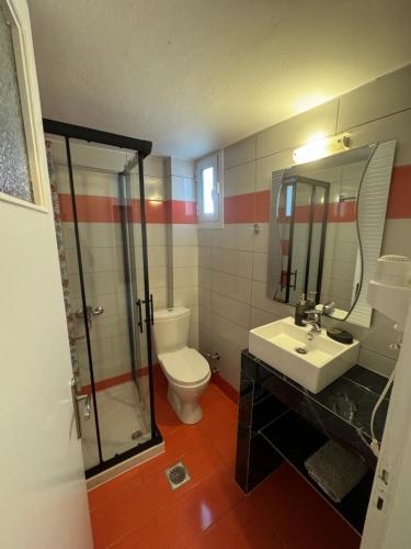 a bathroom with a toilet and a sink and a shower at Mano’s House Preveza in Preveza