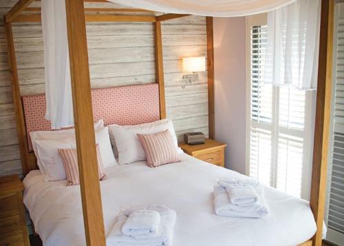 a bedroom with a bed with two towels on it at The Sherwood Hideaway Lodges 