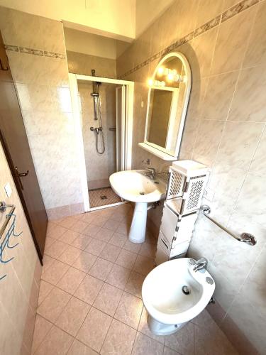 a bathroom with a sink and a toilet and a shower at RESIDENCE SOLARIUM, CORMOR 33 in Bibione