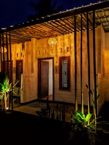 a house lit up at night with a chandelier at Alfarizi homestay in Tetebatu