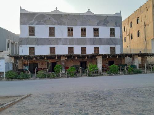 un edificio con un mural en el costado en نزل كوفان التراثي Koofan Heritage Lodge en Salalah