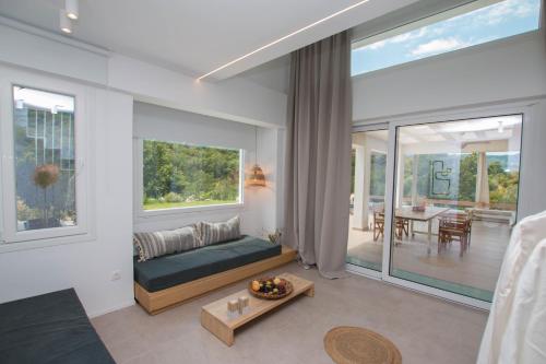 a living room with a couch and a table at Aristotelia Gi - Premium Luxury Villas with Private Pools in Olympiada