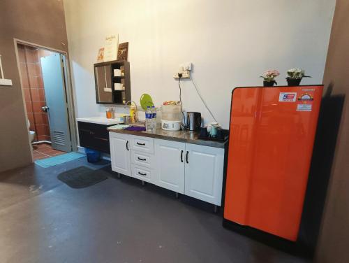 a kitchen with a red refrigerator and a sink at Melaka Riviera Studio 15 in Melaka