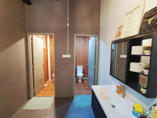a bathroom with a sink and a toilet in it at Melaka Riviera Studio 15 in Melaka