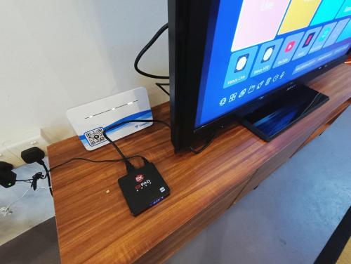 a remote control is hooked up to a tv at Melaka Riviera Studio 15 in Melaka
