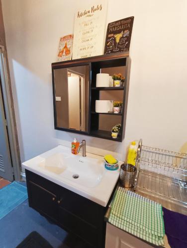 a bathroom with a sink and a mirror at Melaka Riviera Studio 15 in Melaka