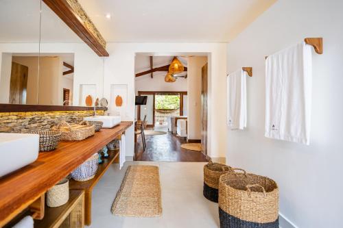 a bathroom with a counter with baskets on it at Aldeia Jericoacoara - Suites Privativas in Jericoacoara