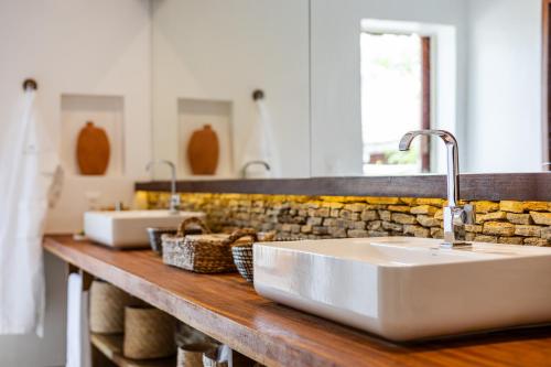 a bathroom with two sinks on a wooden counter at Aldeia Jericoacoara - Suites Privativas in Jericoacoara