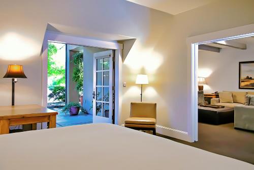 a bedroom with a bed and a living room at Appellation Lodi - Wine & Roses Resort and Spa in Lodi