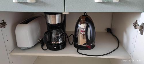 a coffee maker and a blender sitting on a shelf at Autrefois la Cure in Bonnefontaine