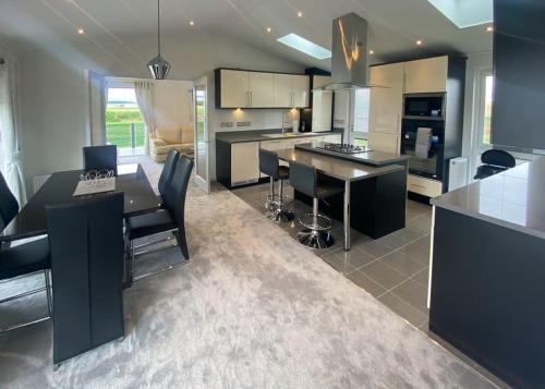 a kitchen with a table and a counter top at Royal Arch Park in Fettercairn