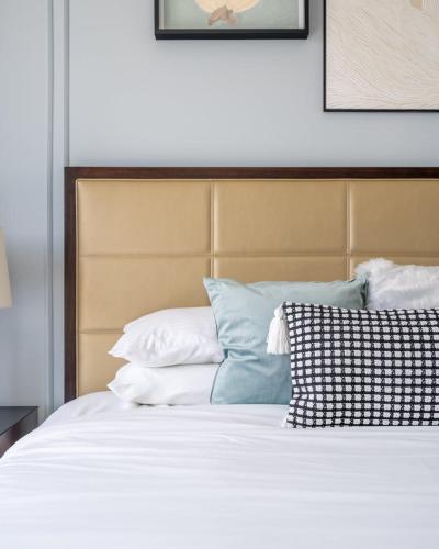a bed with white sheets and pillows in a bedroom at GuestReady - Marina Walk View at JW Marriott in Dubai