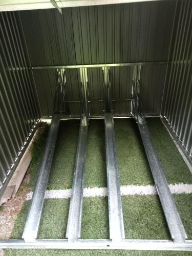 an inside view of a metal cage with grass at RUSTICO ALLE MURA Love & Bike in Toirano