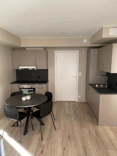 cocina con mesa y sillas en una habitación en First Apartment Lillestrøm, en Lillestrøm