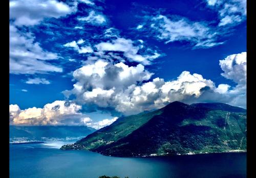 an island in the ocean under a cloudy sky at Villa Diomira in Cannobio