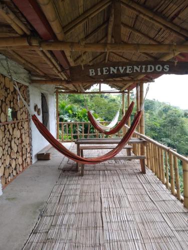 a hammock on a porch of a building at Posadas rurales arabi in Pereira