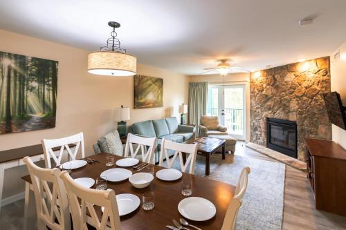 a dining room and living room with a table and a fireplace at Laurel Point Resort in Gatlinburg