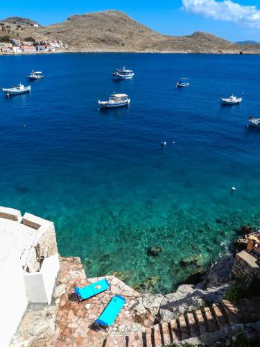 a view of a large body of water with boats at Porphyra Studio in Halki