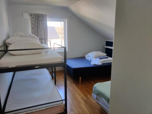 a room with two bunk beds and a window at FeelHome 4 bedrooms apartment Polarvegen in Tromsø