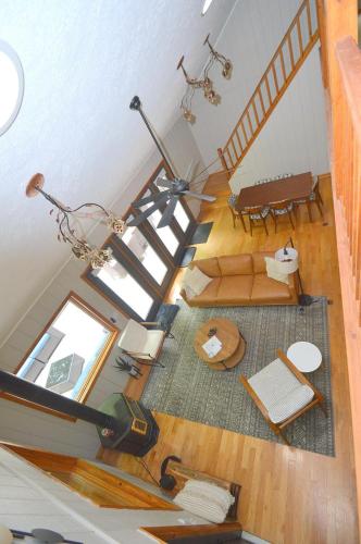 an overhead view of a living room with a staircase at Bobcat 22 -- Hot Tub, Game Room, Wifi, Fire Pit, Pool Access, Fireplace, Grill, Screen Porch, Hiking, Deck, King Bed, Pet Friendly in Berkeley Springs