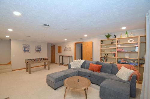 a living room with a couch and a table at Bobcat 22 -- Hot Tub, Game Room, Wifi, Fire Pit, Pool Access, Fireplace, Grill, Screen Porch, Hiking, Deck, King Bed, Pet Friendly in Berkeley Springs