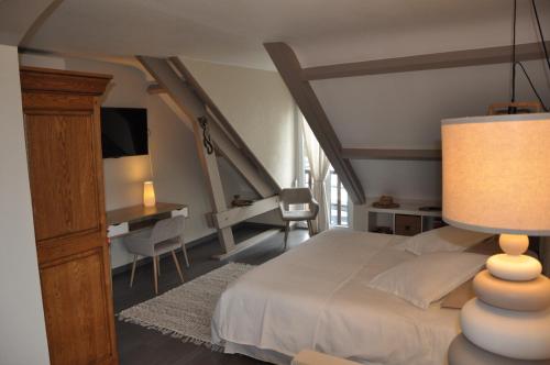 a bedroom with a bed with a table and a desk at La Villa Séquoia in Les Bordes-Aumont