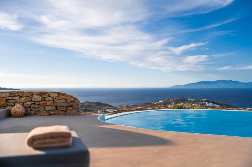 a swimming pool with a view of the ocean at Velanos Villa in Plintri