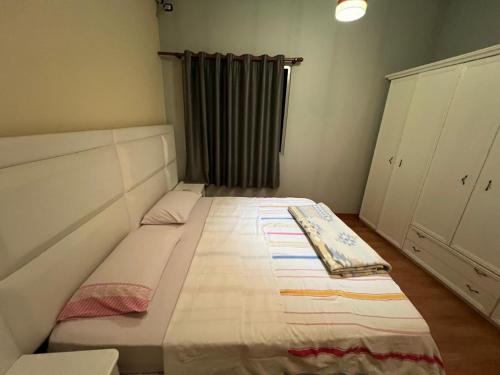 a small bedroom with a bed in a room at Apartment 189 in Tirana