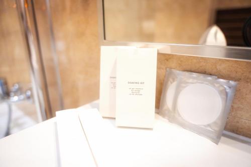 a bathroom with a toilet and a box on a counter at BRISTOL Hotel Opatija in Opatija