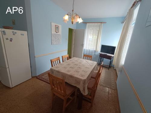 a dining room with a table and a refrigerator at Apartmány Eva in Batňovice