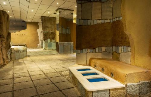 a large room with a tub in the middle of a building at Ilunion Les Corts Spa in Barcelona