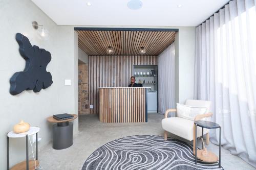 a man is standing at a counter in a lobby at Cradle Boutique Hotel in Lanseria